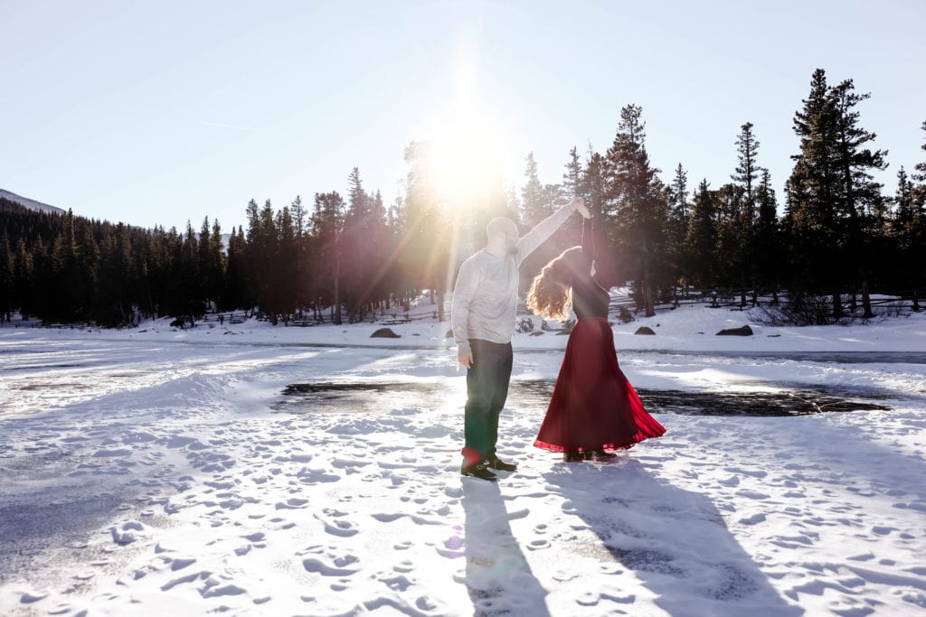 Family Photographer, man and woman dance in the snow